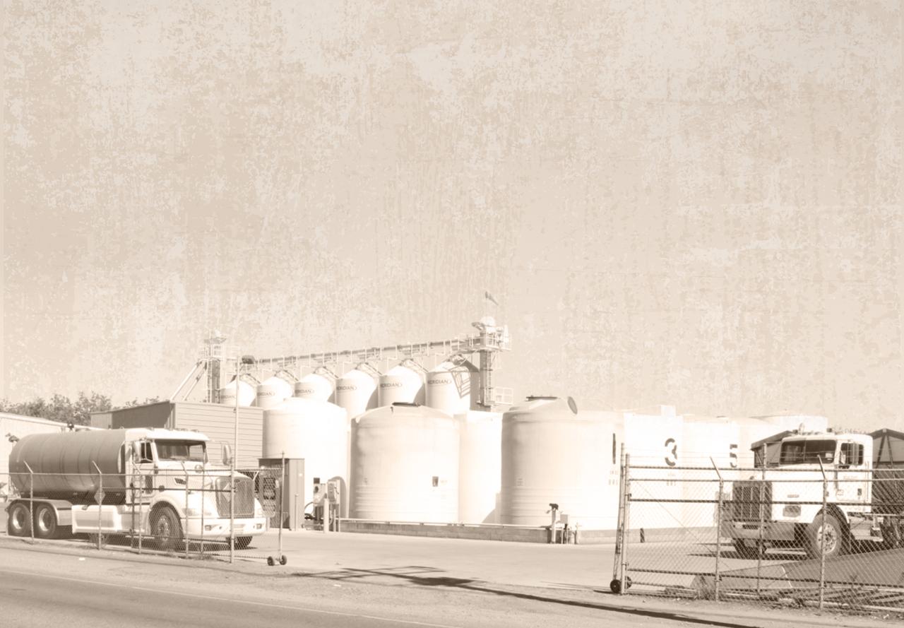 Historic photo of Bear River Supply trucks and storage tanks